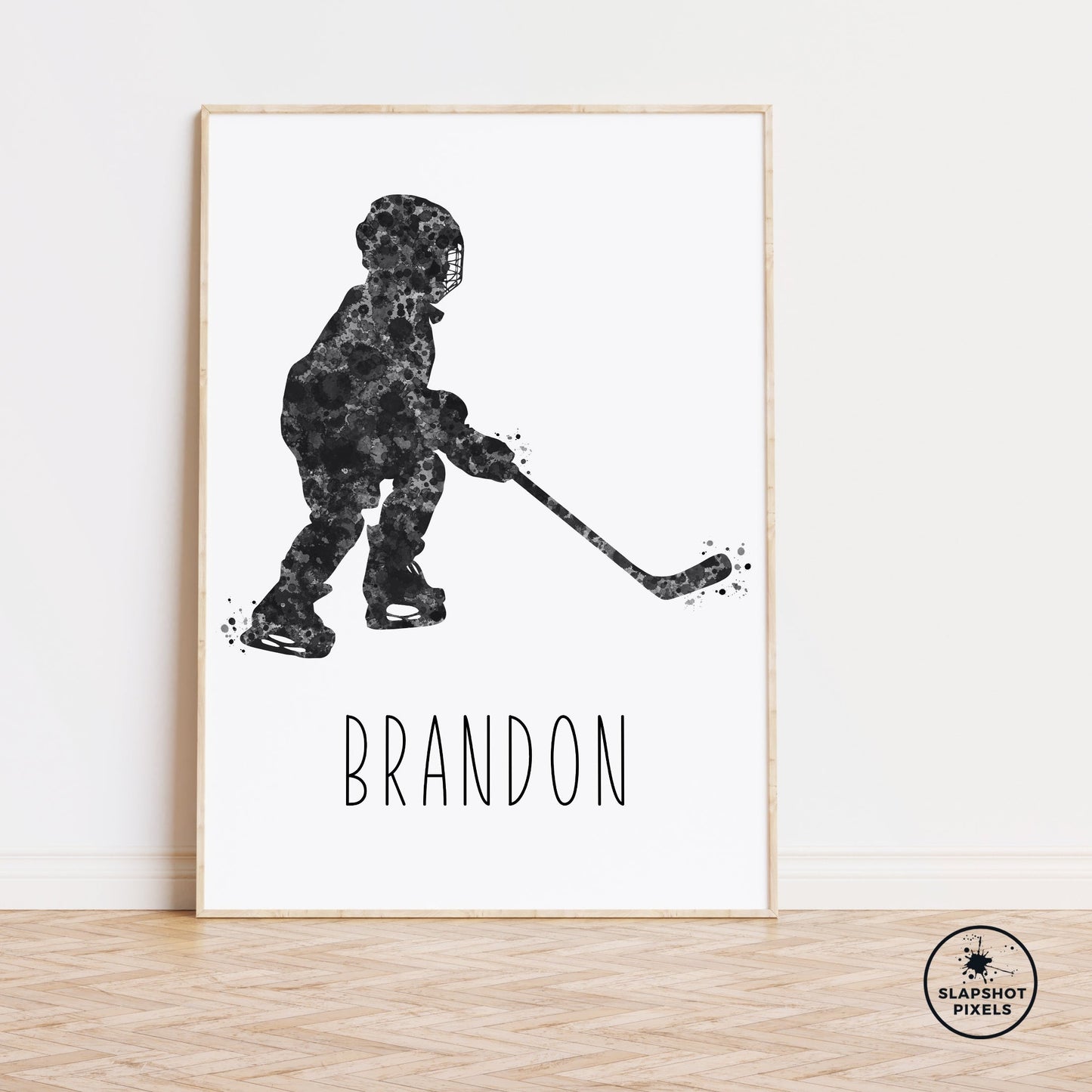 Personalized hockey poster of a child hockey player holding a hockey stick with custom name under the player. Designed in black and grey watercolor splatters. Perfect hockey gifts for boys, hockey team gifts, hockey coach gift, hockey wall art décor in a hockey bedroom and birthday gifts for hockey players.