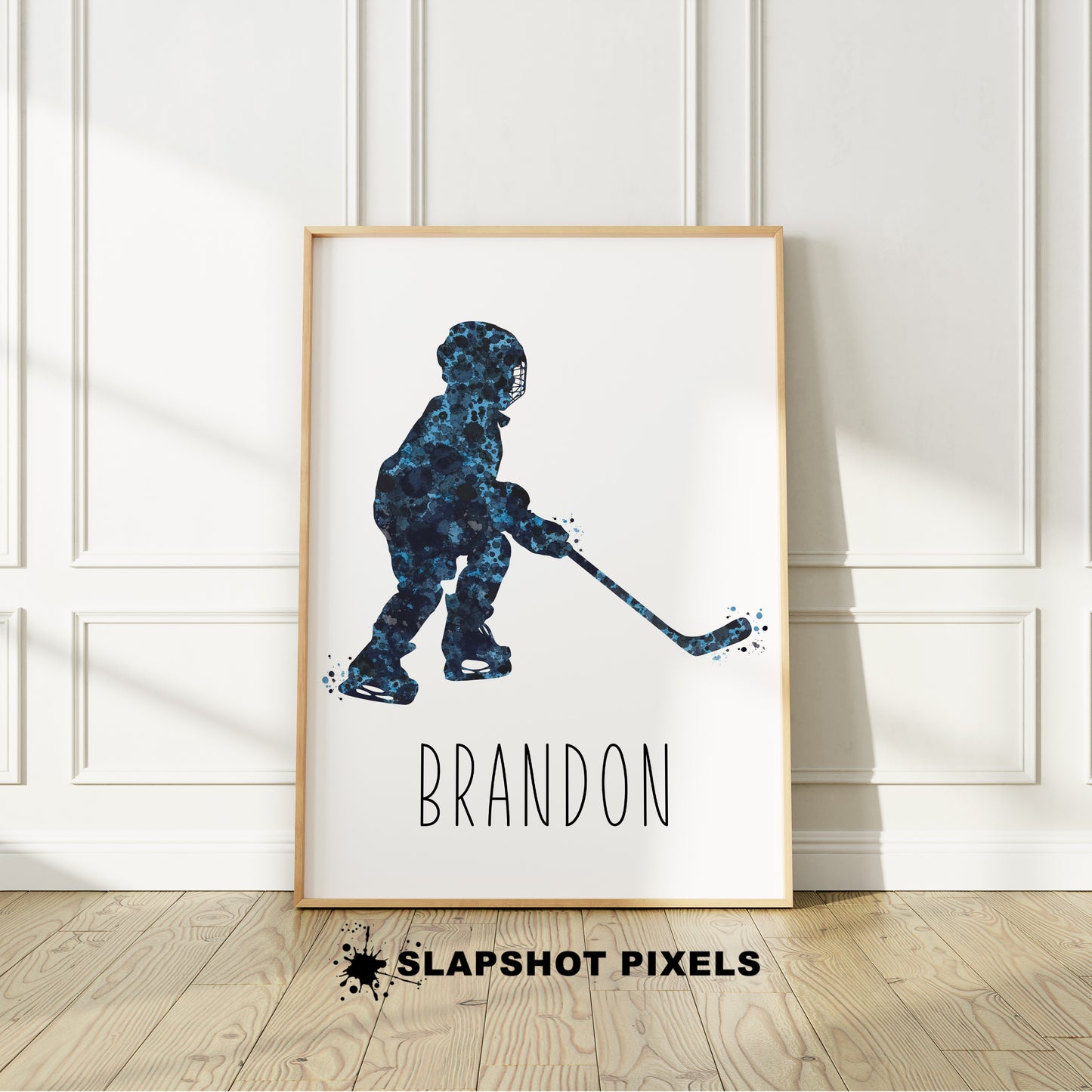 Personalized hockey poster of a child hockey player holding a hockey stick with custom name under the player. Designed in blue and black watercolor splatters. Perfect hockey gifts for boys, hockey team gifts, hockey coach gift, hockey wall art décor in a hockey bedroom and birthday gifts for hockey players.